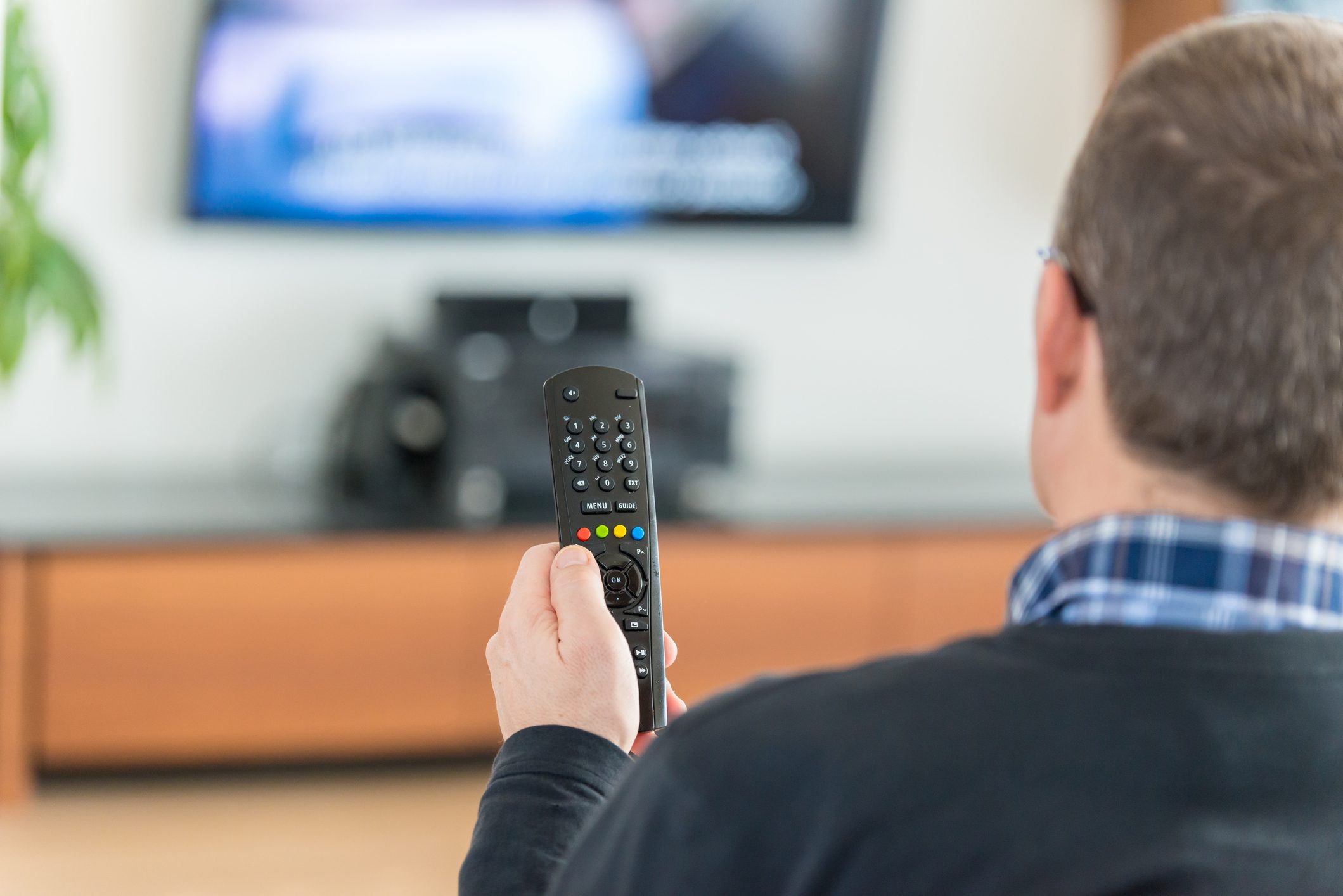 Man using TV Remote Control